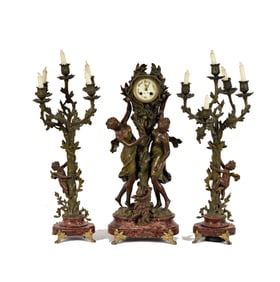 A French Spelter Figural Group Mantle Clock with Candelabra