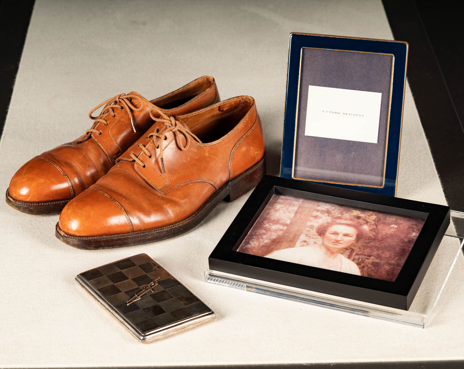 Group of Bugatti Family Personal Effects: from the Mullin Museum's main showroom, including one photograph of Theresa Bugatti (wife of Carlo Bugatti), Ettore Bugatti shoes signed on the sole by Ettore Bugatti and a John Bugatti Cigarette Case