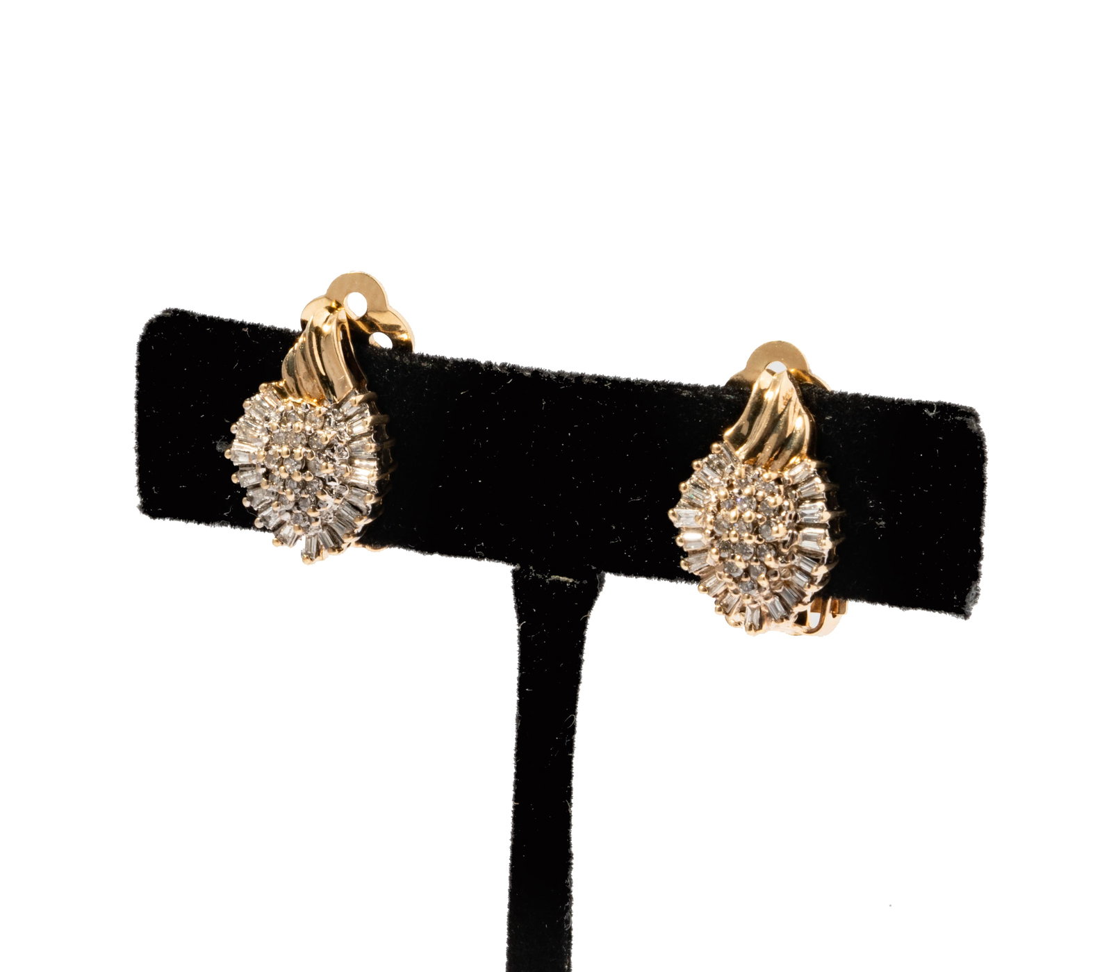 A Pair of Yellow Gold and Diamond Clip Earrings: 10 karat yellow gold earrings with 14 karat yellow clip backings, earrings set with 28 small round diamonds weighing approximately .25 carats, accented with 34 tapered baguette and baguette-shaped dia