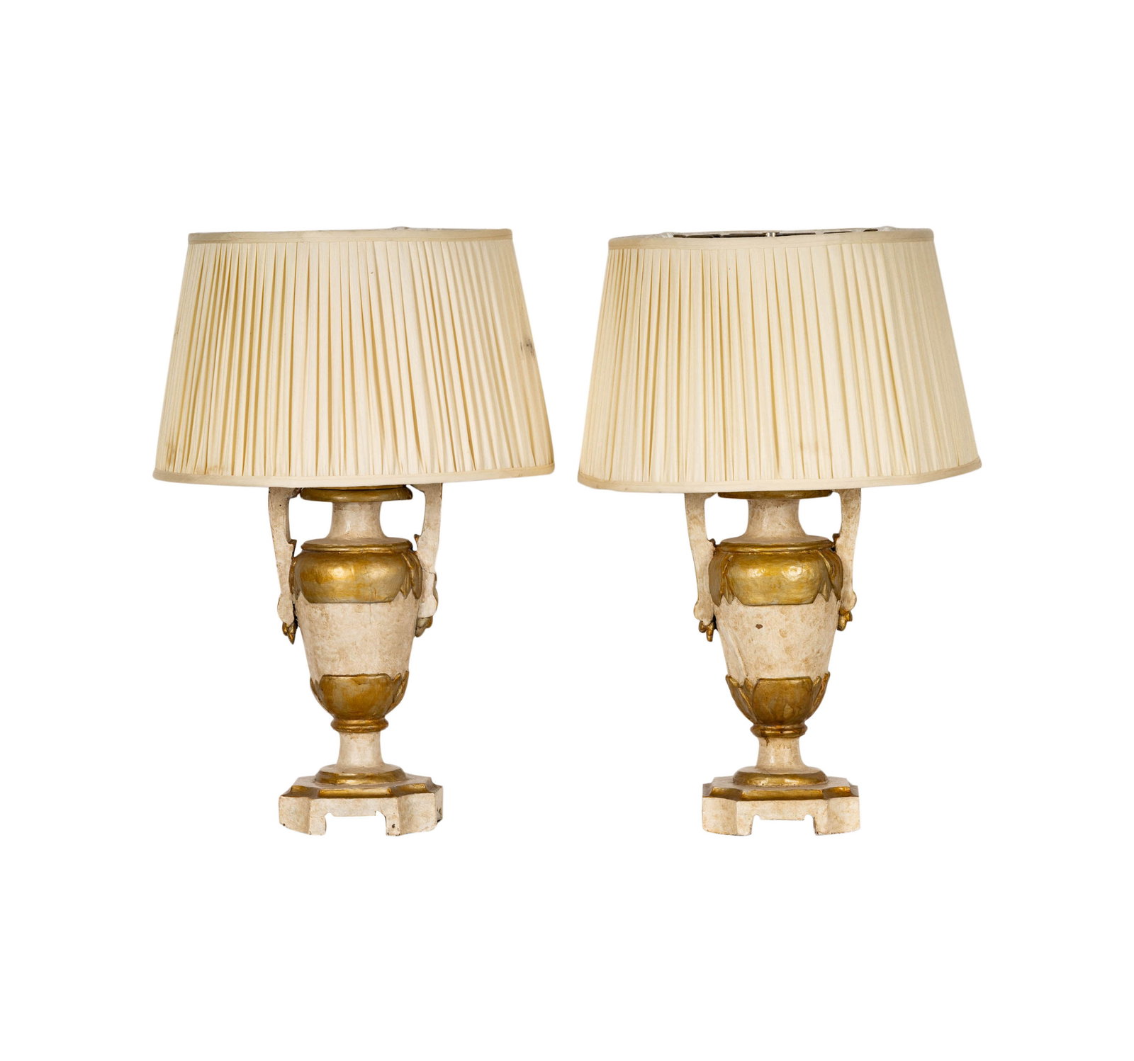 A Pair of Italian Gilt and White-Painted Wooden Urns: each mounted as a table lamp Excluding mounts: 18 1/2 in. (47 cm.), Overall: 30 in. (76.2 cm.) high Provenance: Property from the collection of George Doan, Philadelphia, PA. and Rancho Mirage, CA