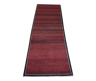 An Indian Red and Black Runner Rug