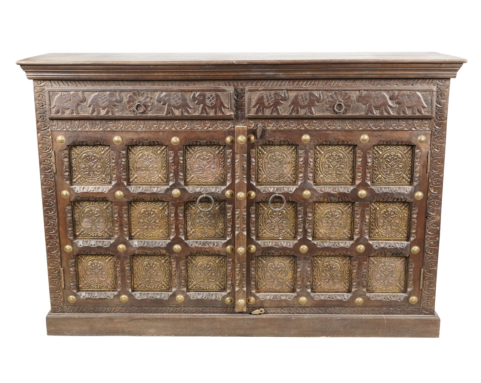 An Indian Brass-Mounted Carved Wood Cabinet: 20th century; the frieze carved with elephants 40 1/2 x 59 1/4 x 15 3/4 in. (102.9 x 150.5 x 40 cm.) Notes: This item does not qualify for in-house shipping. Please see our preferred shippers list for