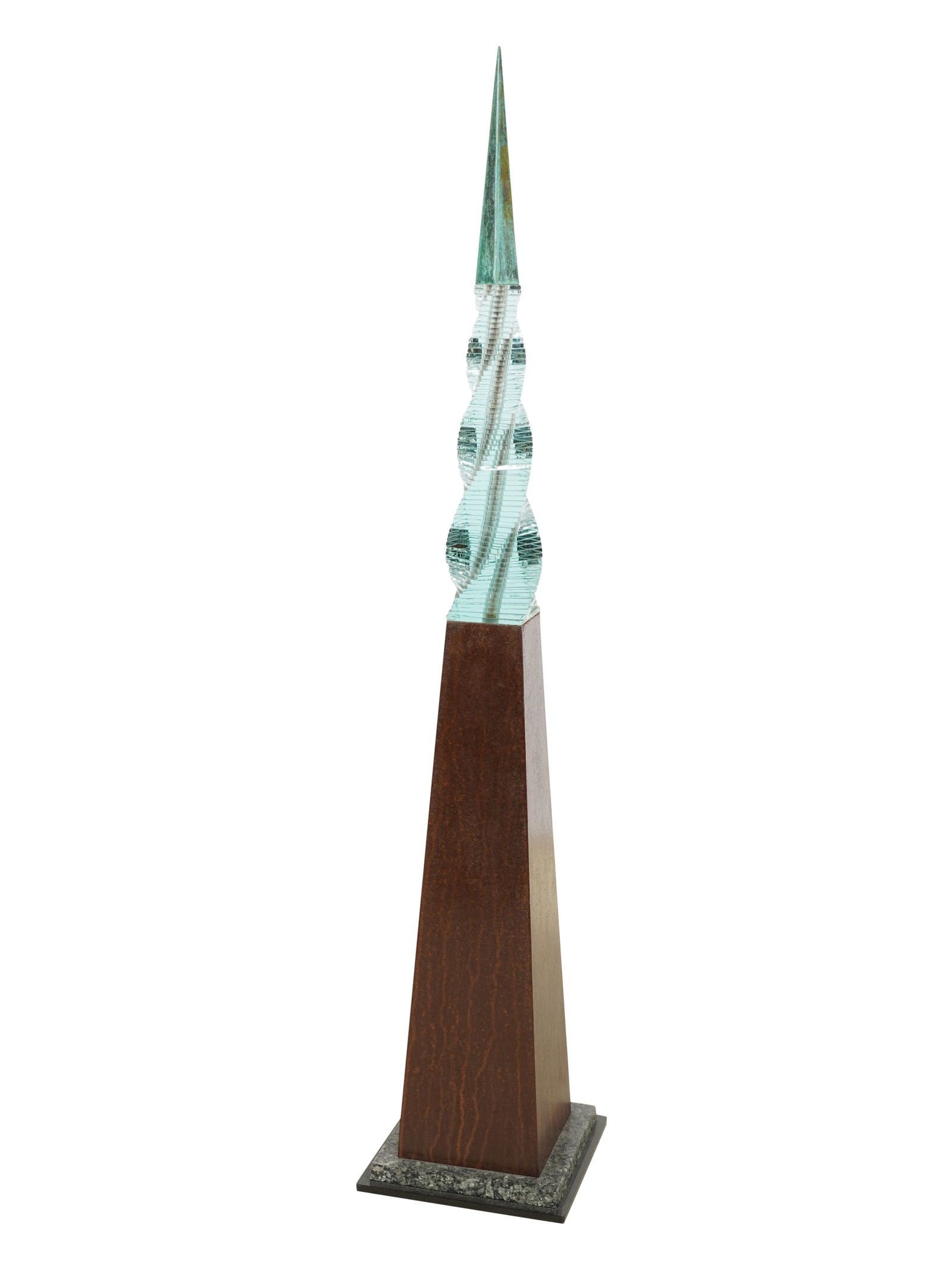 A Sculptural Obelisk: in the style of Mario Ceroli; cut glass, patinated metal, granite; apparently unsigned 51 x 10 in. (129.5 x 25.4 cm.) Notes: This item does not qualify for in-house shipping. Please see our preferred
