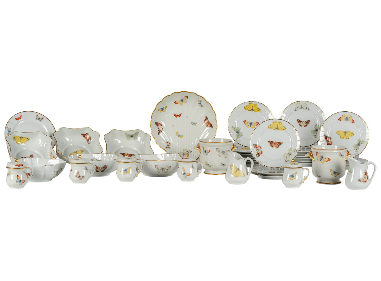 A Bernardaud Limoges Butterfly Porcelain Partial Service: comprising 19 bread plates (6 1/2 in. dia.), six square serving bowls (6 1/2 x 6 1/2 in.), five pots de creme, two cachepots (4 1/2 x 4 1/2 in.), two creamers (4 in. high), one salad plate (7 3/8 in.)