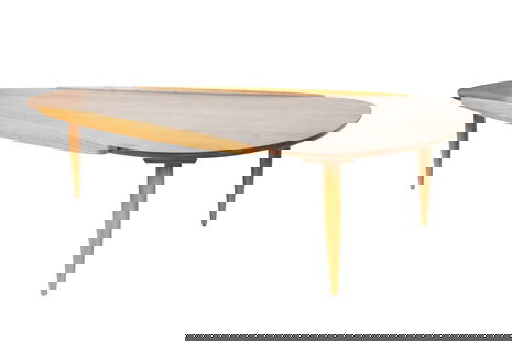 A Mid-Century Modern Triangular Coffee Table: stained wood in two tones; unsigned 16 x 66 1/4 x 39 in. (40.6 x 168.3 x 99.1 cm.) Notes: This item does not qualify for in-house shipping. Please see our preferred shippers list for quotes or arrange