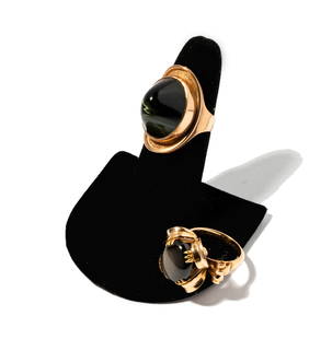 Janis Paige: Two Yellow Gold Gem-set Rings: including one 9 carat bezel set tigers eye ring size: 7-1/4, the other 14 karat yellow gold prong set black star sapphire ring size: 7; weighing 19.3 grams; Provenance: The Estate of Janis Paige, Bel