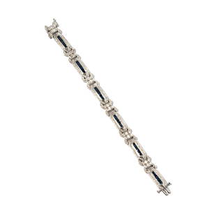 Janis Paige: 18 Karat White Gold Diamond and Sapphire Bracelet: set with 48 baguette cut sapphires weighing approximately 1.70 carats and accented with 263 small full cut diamonds[H-I/SI] weighing approximately 2.60 carats; bracelet measuring 7 inches long by