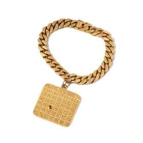 Janis Paige: Cartier 14 Karat Yellow Gold Curb link Bracelet With Calendar Charm