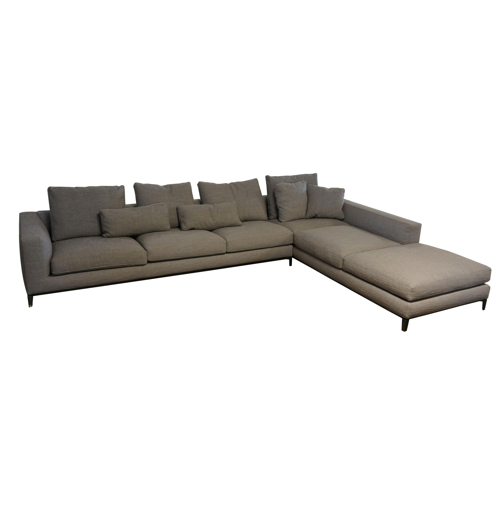 A Minotti Gray Fabric-Upholstered Sectional Sofa: in two parts; with steel legs; with manufacturer's tag Right-arm section: 24 x 105 x 40 in. (61 x 266.7 x 101.6 cm.), Chaise longue: 24 x 40 x 105 in. (61 x 101.6 x 266.7 cm.) Notes: This item does no