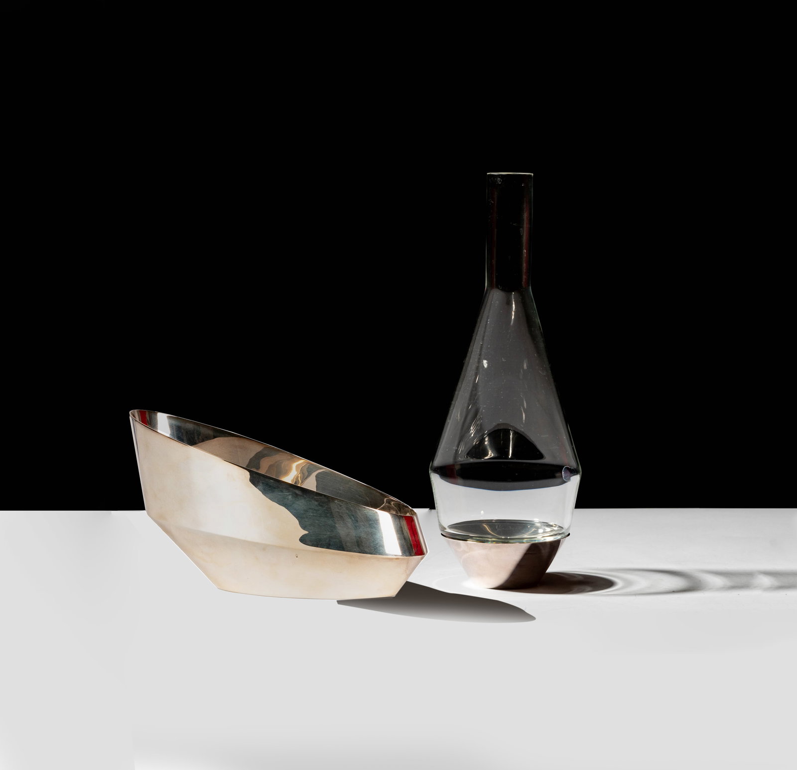 A Puiforcat Decanter and Wine Caddy: each marked to underside Decanter: 14 1/2 x 5 1/4 in. (36.8 x 13.3 cm.), Caddy: 5 1/2 x 10 x 4 1/4 in. (14 x 25.4 x 10.8 cm.)