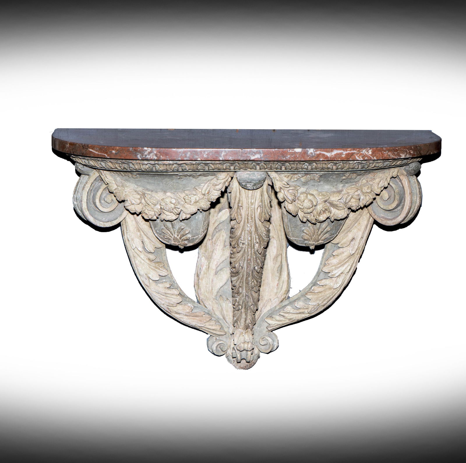 A Continental Baroque Painted Wood Console Table: wall-mounted, with D-shaped marble top 18 3/4 x 27 3/4 x 13 3/4 in. (47.6 x 70.5 x 34.9 cm.) Provenance: Property from the collection of George Doan, Philadelphia, PA. and Rancho Mirage, CA Notes: Thi