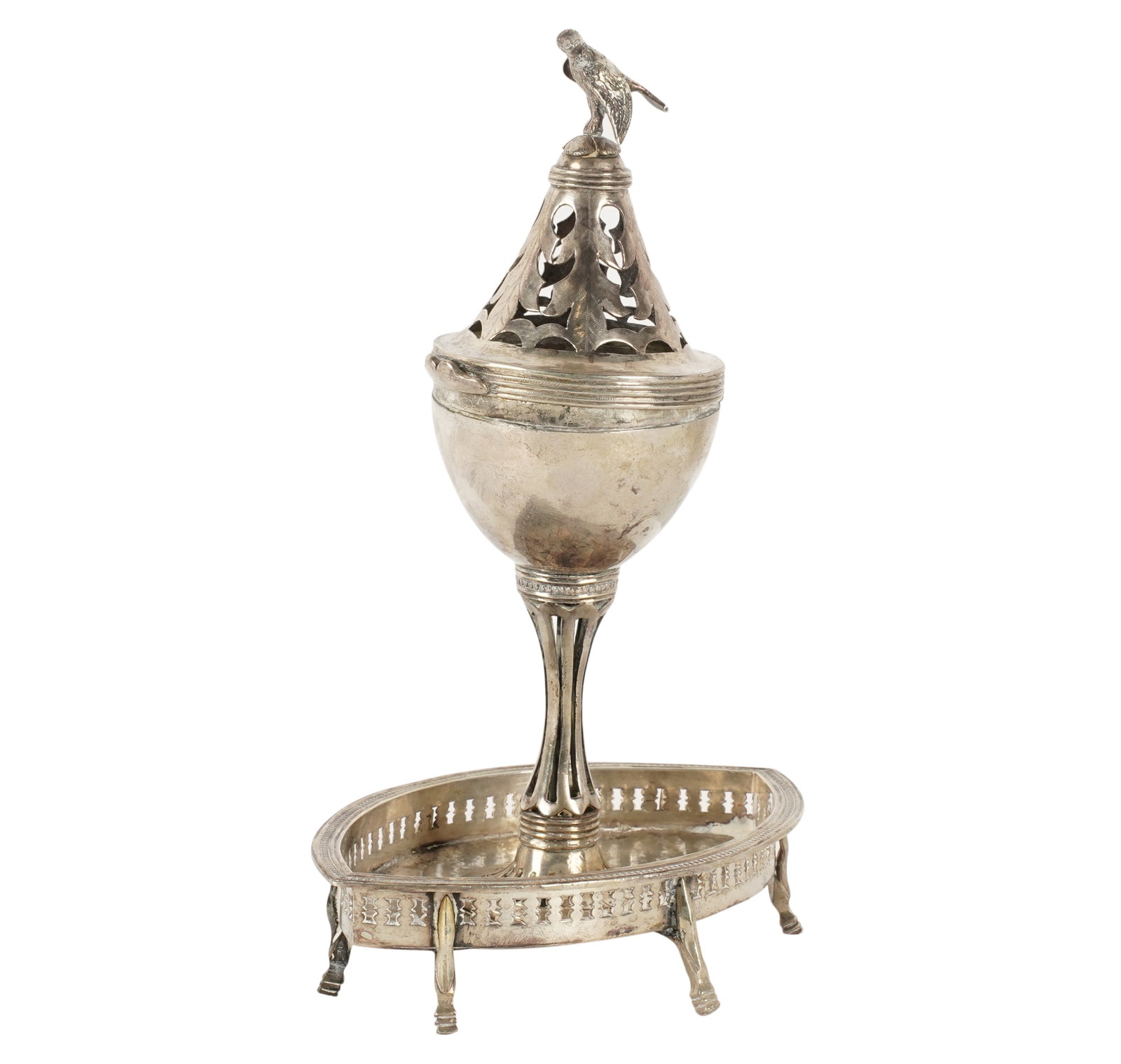 A Spanish Colonial Pastille Burner: with bird-form finial and pierced hinged lid, on a pierced support and base, with six feet; unmarked; metal content untested; Approximately 386 grams 9 1/2 x 6 1/2 x 4 1/2 in. (24.1 x 16.5 x 11.4 cm.)