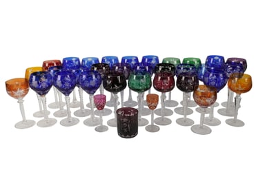 A Large Collection of Etched Colored Glass Stemware