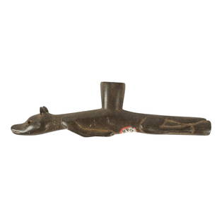 A Native American Effigy Pipe: carved stone 8 in. (20.3 cm.) wide