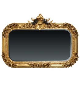 A Carved Gilt and Ebonized Wood Wall Mirror