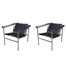 A Pair of Black Leather and Chromed Metal Armchairs