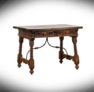 A Spanish Baroque Walnut Trestle Table: 18th century; with two carved drawers and an iron stretcher 32 x 43 3/4 x 29 1/4 in. (81.3 x 111.1 x 74.3 cm.) Notes: This item does not qualify for in-house shipping. Please see our preferred shipper