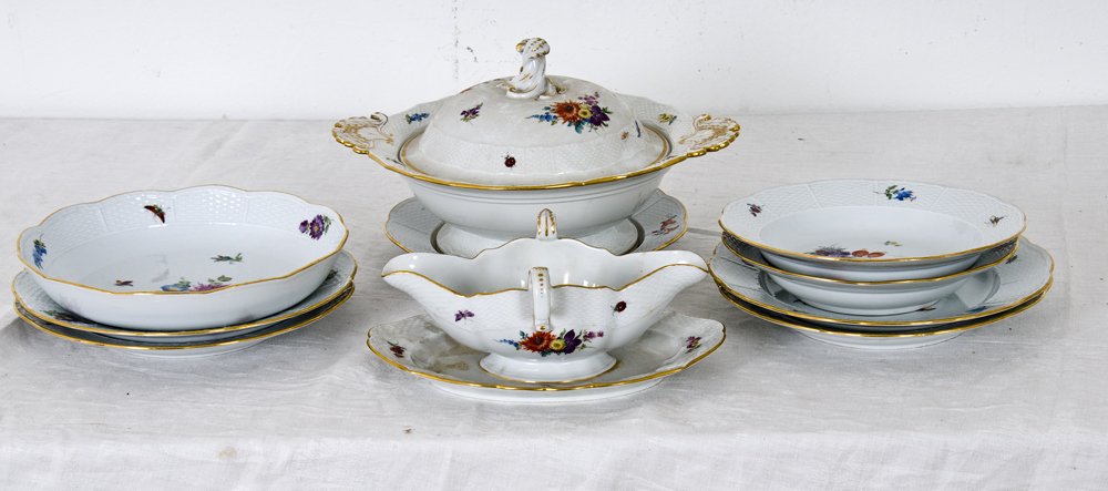 MEISSEN PORCELAIN PARTIAL DINNER SERVICE: comprising of 42 pieces: 17 dinner plates (10"), 10 salad plates (8"), 10 soup bowls (9"), two serving bowls, one sauce boat, and a covered tureen; along with damaged and broken pieces