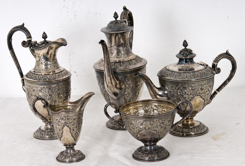 EDWARDIAN STERLING SILVER TEA SERVICE: each body with floral chasing; six pieces comprising: tea pot, hot water pot, coffee pot, creamer and open sugar 95 total troy ounces