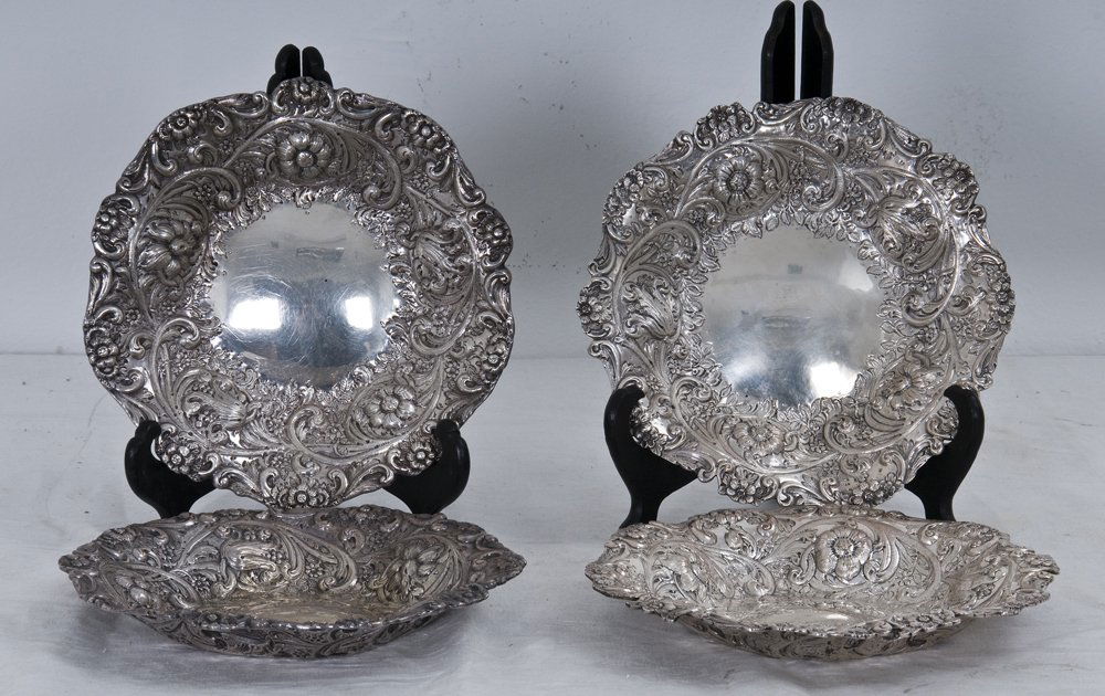 FOUR VICTORIAN SILVER REPOUSSE BOWLS: Charles Stuart Harris, London, 1889-90 each with a floral repousse rim 32 total troy ounces Condition: only two with identifiable hallmarks 9 1/2 inches diameter