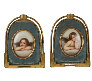 A Pair of Painted Porcelain Miniatures of Cherubs