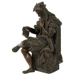 A Bronze Figure of a Seated Man Reading a Book