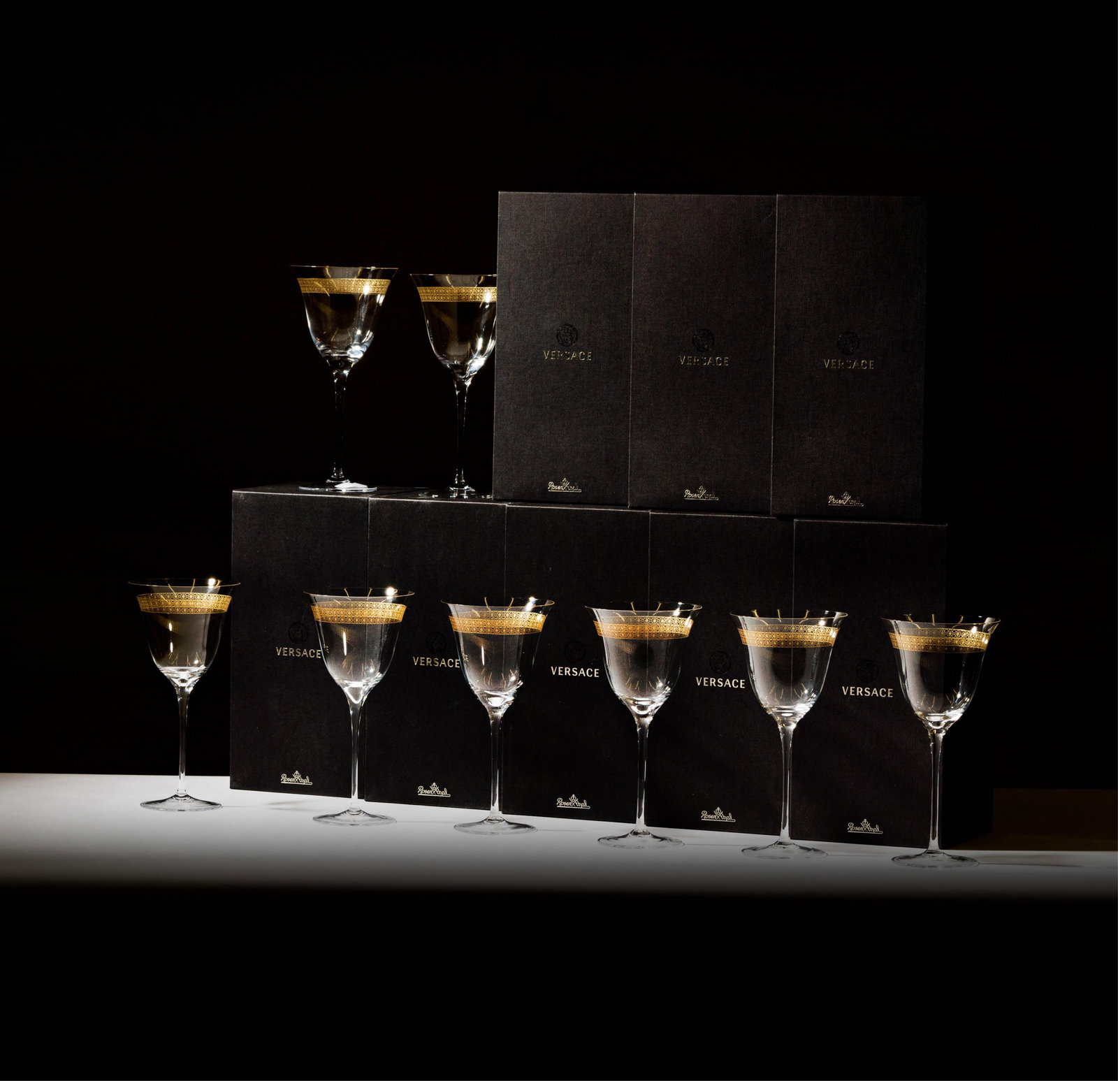 Eight Versace Rosenthal Gilt Crystal Wine Glasses: each signed, 8 7/8 x 4 3/8 in. (22.5 x 11.1 cm.); each with original box, 6 x 12 1/4 x 6 1/4 in. (15.2 x 31.1 x 15.9 cm.)