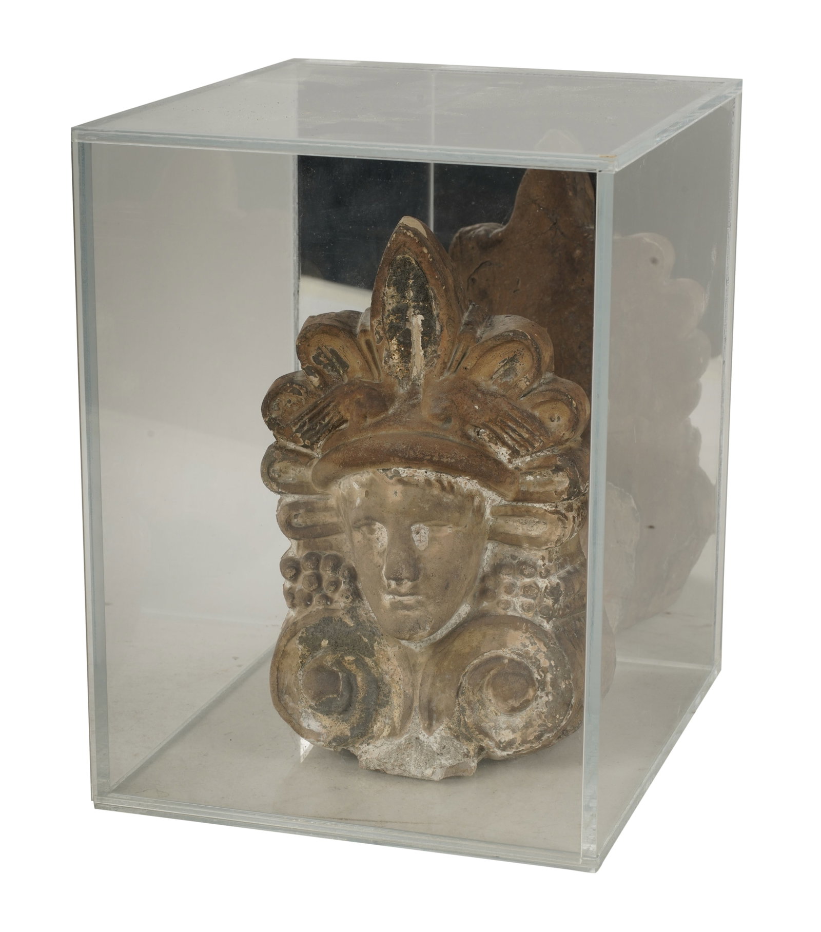 An Archaic- Style Carved Head: in an acrylic case,Case: 10 1/2 x 8 x 9 1/2 in. (26.7 x 20.3 x 24.1 cm.)