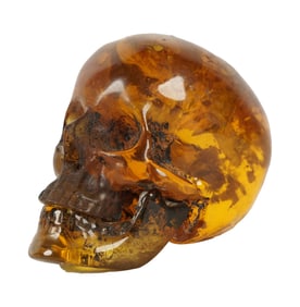 A Miniature Carved Amber Momento Mori Skull
