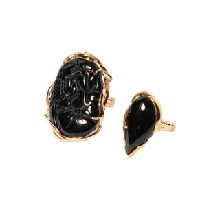 TWO 14-KARAT YELLOW GOLD BLACK ONYX RINGS: two rings featuring black onyx; pear-shape cabochon-cut black onyx measuring 30 x 24.5 mm bezel-set with a 14-karat yellow gold swirl motif ring, and one ring comprised of 14-karat yellow gold with a