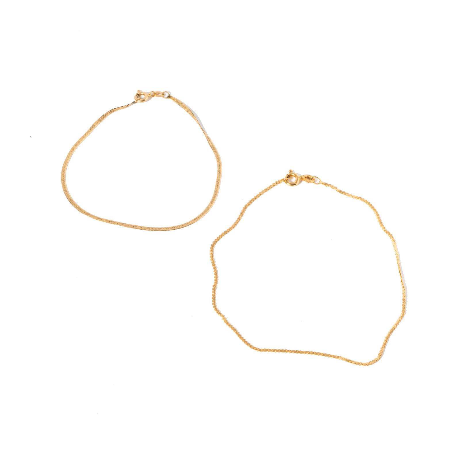 TWO YELLOW GOLD CHAIN BRACELETS: featuring two chain bracelets: one 9-karat yellow gold 9" long and one 14-karat yellow gold 7" long, 2.4 grams total weight; inscribed 9KT and 14KT