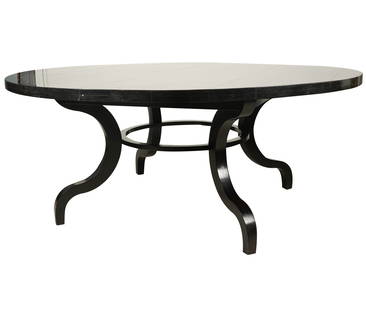 A Dessin Fournir Ebonized Dining Table: the round top on four curved legs joined by a round stretcher; unsigned 30 x 72 in. (76.2 x 182.9 cm.)Notes: This item does not qualify for in-house shipping. Please see our preferred shippers' list f