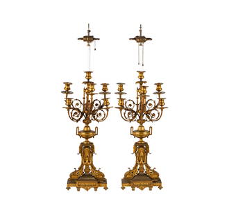 A Pair of French Bronze Candelabra Lamps: late 19th century; each in two tones, with scenic panels to base; wired for electricity40 x 12 x 9 in. (101.6 x 30.5 x 22.9 cm.)Notes: This item does not qualify for in-house shipping. Please see our