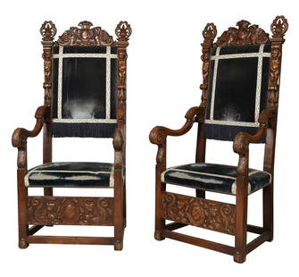 A Pair of Renaissance Revival-Style Hall Chairs: carved walnut63 1/2 x 28 x 24 in. (161.3 x 71.1 x 61 cm.), Seat height: 20 in. (50.8 cm.)Notes: This item does not qualify for in-house shipping. Please see our preferred shippers' list for quotes or