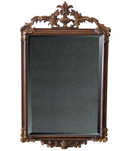 A Carved Wood Wall Mirror: after 1950; the beveled mirror plate with "antiqued" effect63 x 37 1/2 in. (160 x 95.3 cm.)Notes: This item does not qualify for in-house shipping. Please see our preferred shippers' list for quotes o