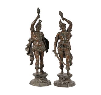 A Pair of Patinated Metal Figures: depicting warriors holding torchesEach: 26 in. (66 cm.) highNotes: This item does not qualify for in-house shipping. Please see our preferred shippers' list for quotes or arrange for local pickup. htt