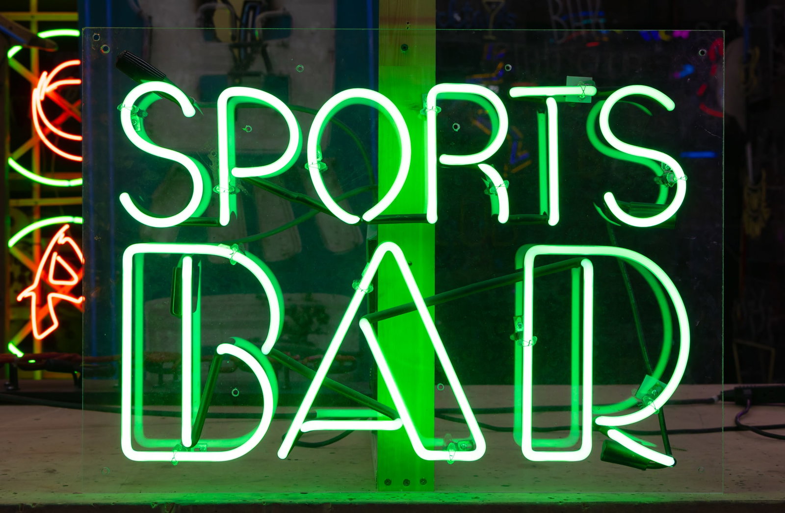 Sports Bar Neon Sign: green neon mounted to plexiglass backing; transformer included; 20 x 28 in. (50.8 x 71.1 cm.)Notes: This neon sign was featured in several notable film and television productions, including Lethal Wea
