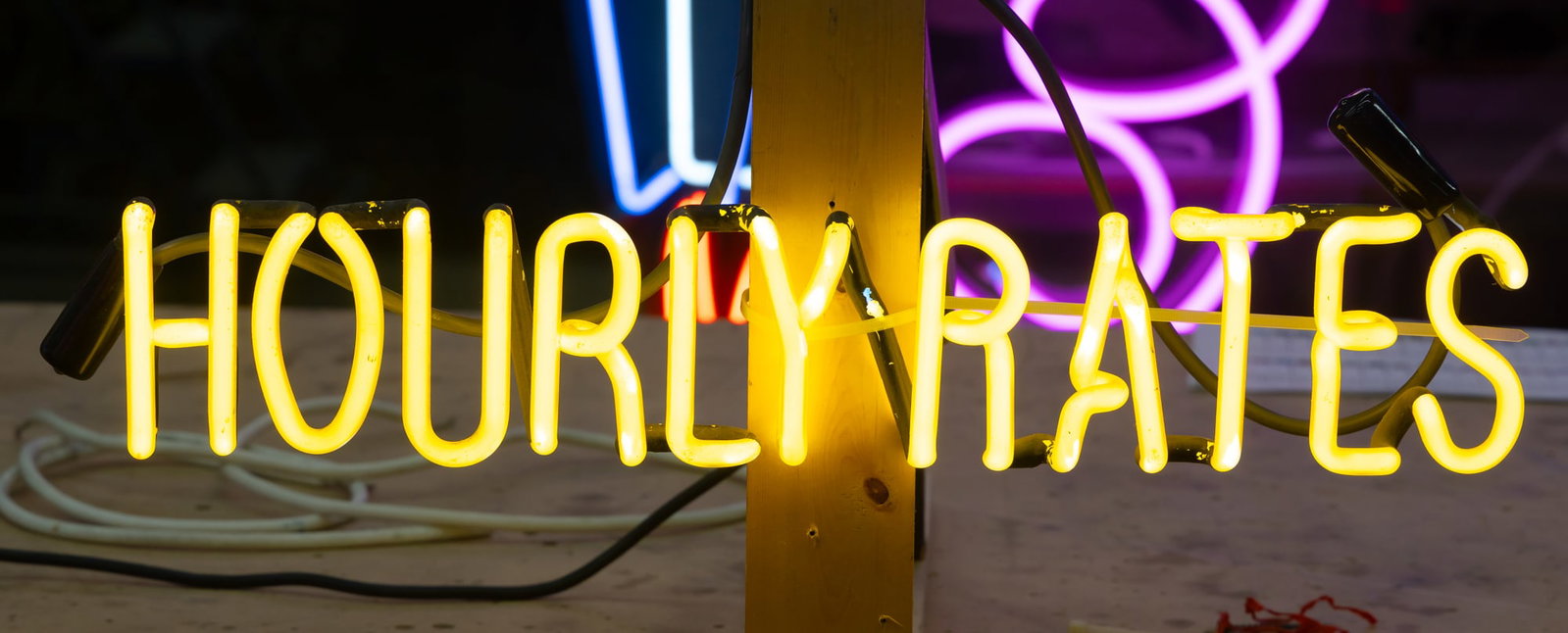 Hourly Rates Neon Sign: with no backing; transformer included; Sign: 4 x 20 in. (10.2 x 50.8 cm.)