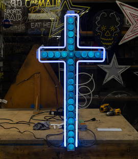 Blue Neon Cross: with blue-tinted bulbs and blue neon surrounding, set on aluminum backing; transformer included; 36 x 18 in. (91.4 x 45.7 cm.); Notes: This neon sign was featured in several notable film and televisio