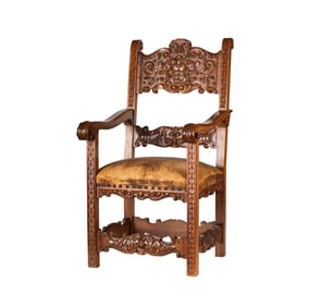 A Carved Oak and Leather Armchair