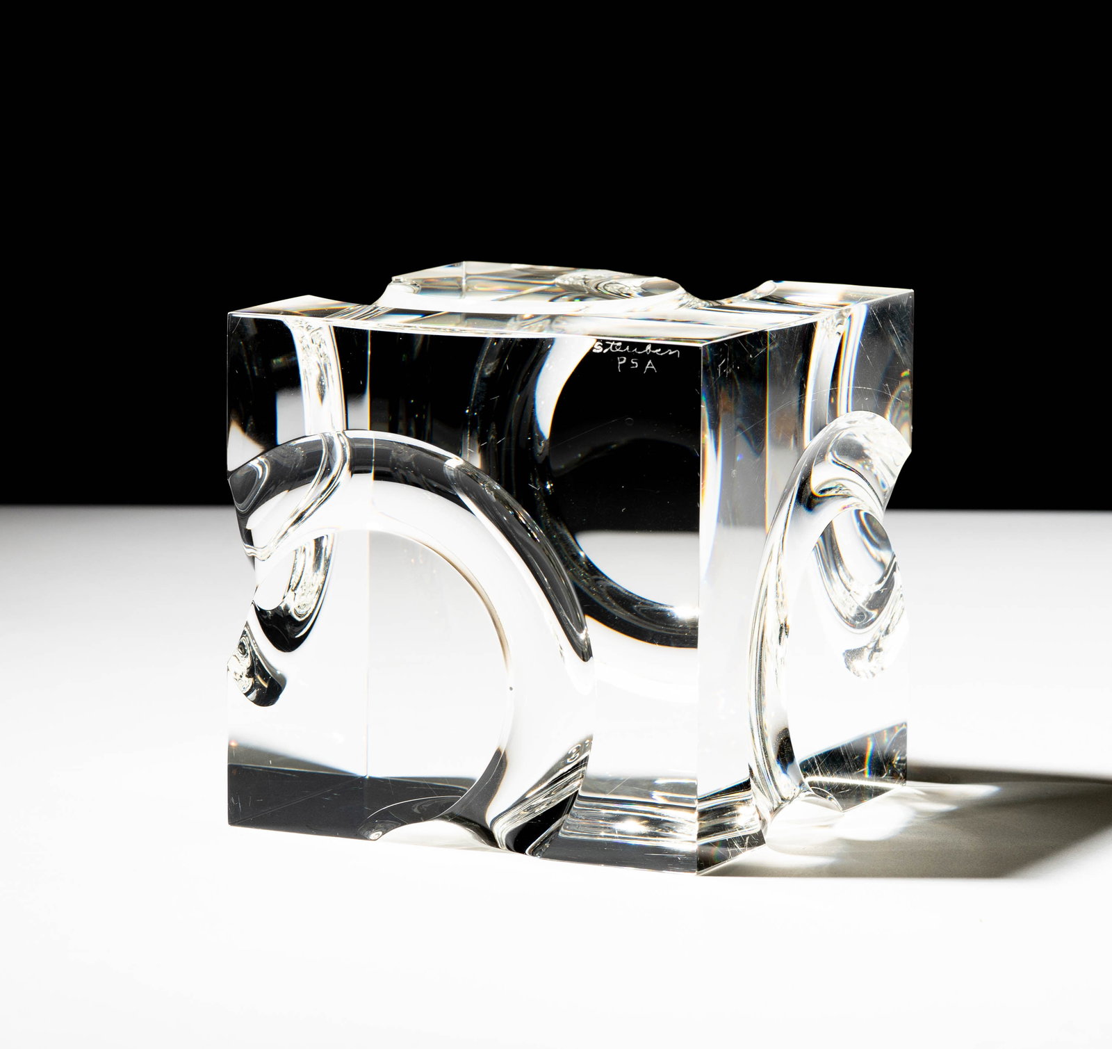 Steuben Glass Passage I Sculpture: designed by Peter Aldridge; signed "Steuben" and "P.S.A."; 4 x 4 x 4 in. (10.2 x 10.2 x 10.2 cm.); With original red leather fitted case: 6 x 8 1/2 x 8 1/2 in. (15.2 x 21.6 x 21.6 cm.); Provenance: Th