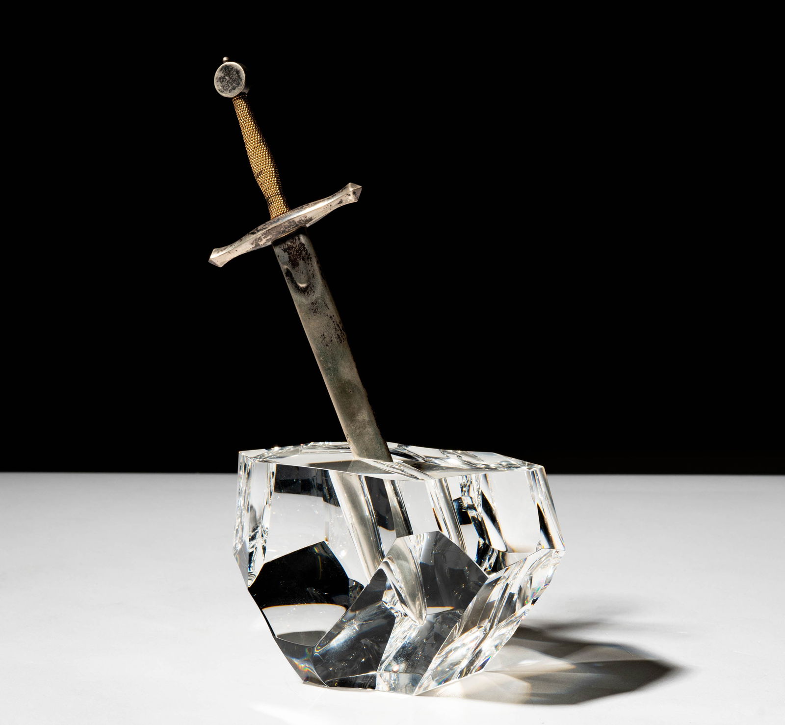 Steuben Glass, Silver, and Gold Sword in The Stone Sculpture: signed; Overall: 8 x 4 1/2 x 3 1/4 in. (20.3 x 11.4 x 8.3 cm.); ; Provenance: The collection of Santa Barbara Steuben collector Joel Kreiner