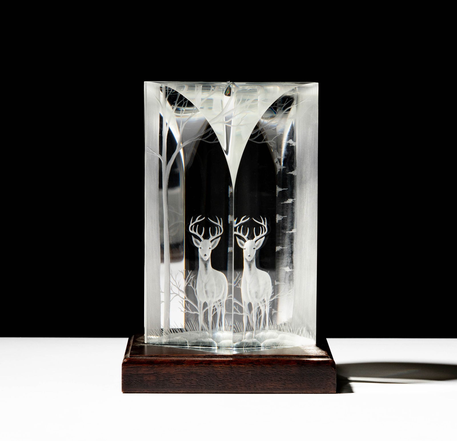 Steuben Glass Elusive Buck Sculpture: designed by Harold Gross; on wooden base; signed; Overall: 7 x 5 x 5 in. (17.8 x 12.7 x 12.7 cm.); ; Provenance: The collection of Santa Barbara Steuben collector Joel Kreiner