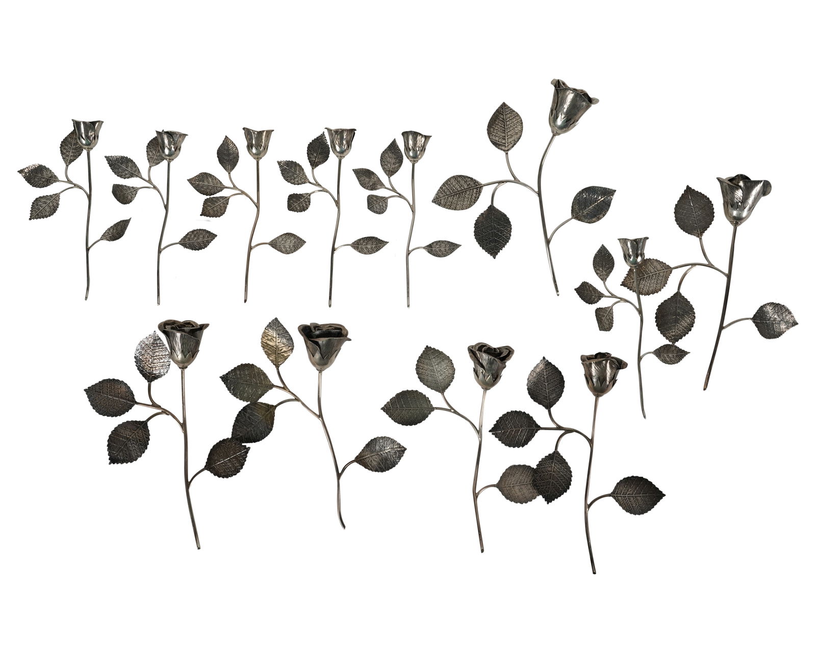 A Group of Masriera Sterling Flowers: comprising twelve stems in two sizes; each marked; Approximately 1,022 grams total Notes: This item does not qualify for in-house shipping. Please see our preferred shippers' list for quotes or arrang