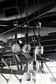 A Group of Five Mid-Century Chrome and Glass Pendant Light Fixtures
