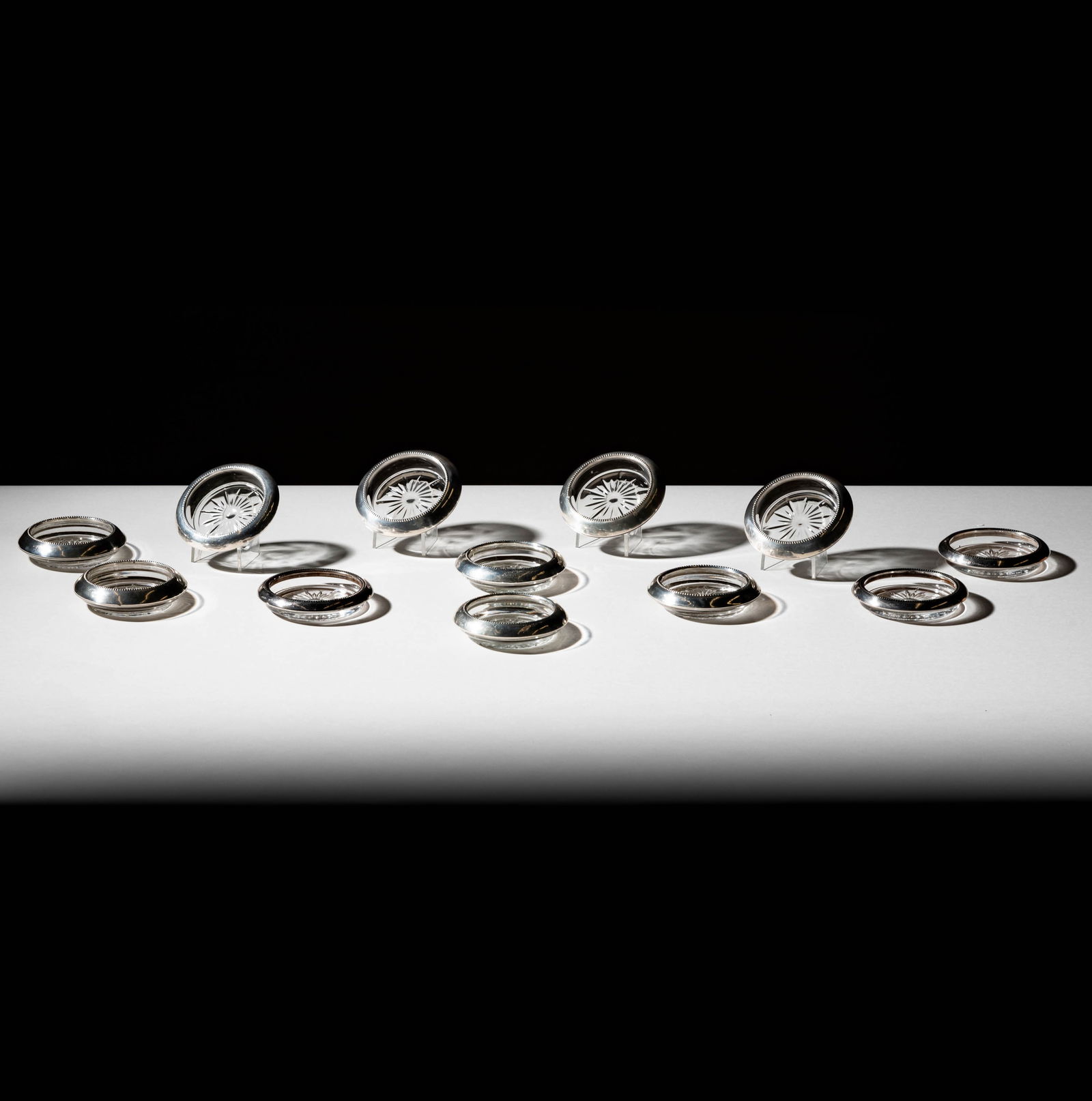 Bob Newhart: 12 American Sterling-Mounted Cut Glass Coasters: Frank M. Whiting Co.; each with maker's mark and further marked "Sterling" Each 3 3/4 in. (9.5 cm.) dia. Provenance: From The Legendary Estate of Bob and Ginnie Newhart, celebrated icons of American e