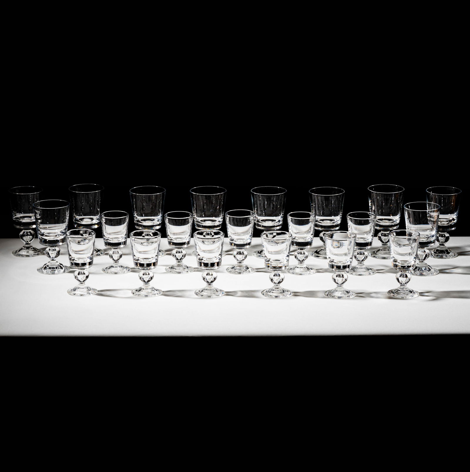 Bob Newhart: A Steuben Crystal Drink Service: comprising ten water goblets [6 1/2 x 3 1/2 in.] and 11 dessert glasses [5 /1/2 x 2 3/4 in.] with etched signature [21 pieces] Provenance: From The Legendary Estate of Bob and Ginnie Newhart, celebrat