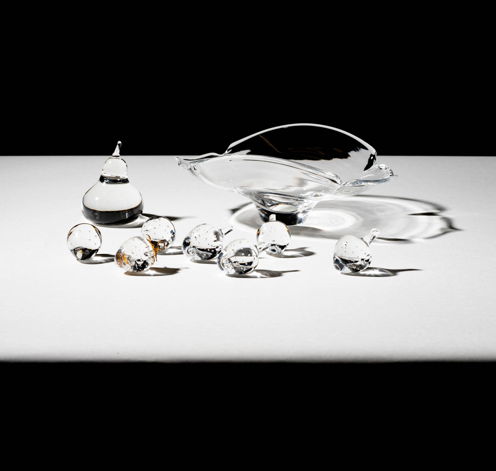 Bob Newhart: A Steuben Glass Bowl and Fruit: each with an etched signature; comprising a pear, a strawberry with a gold top, and six strawberries Bowl: 3 3/4 x 9 1/2 x 7 in. (9.5 x 24.1 x 17.8 cm.) Provenance: From The Legendary Estate of Bob an