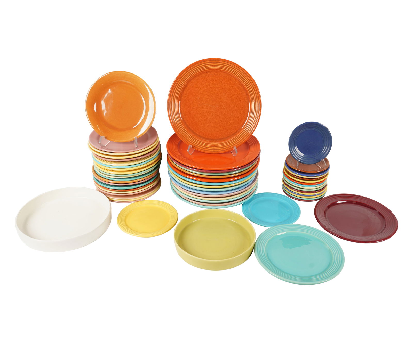 A Group of Vintage Bauer Pottery Dishes: comprising 15 chargers (13 in. dia.), 2 plates (10 3/4 in. dia.), 21 plates (9 1/2 in. dia.), 2 plates (8 in. dia.), 16 plates (6 in. dia.), and two round platters (12 in. dia. and 10 in. dia.); marke