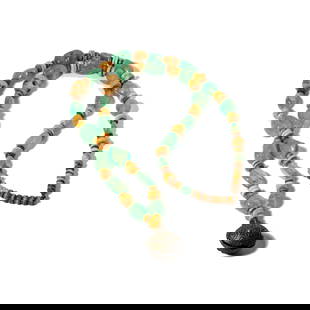 Metal, Emerald and Bone Necklace: including emeralds with varying sizes smallest measuring 13.30mm in length and largest 26.35mm in length; necklace measuring 32 inches wearable neck length; total length from clasp to bell pendant 23